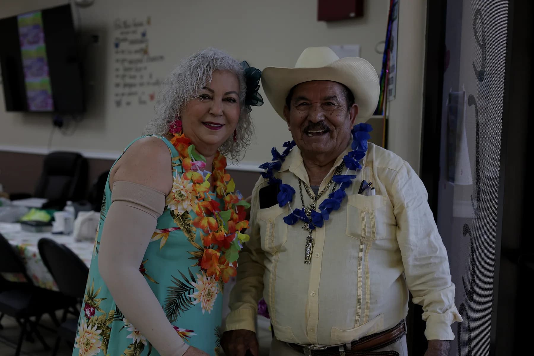 Two participants posing arm in arm during a celebration