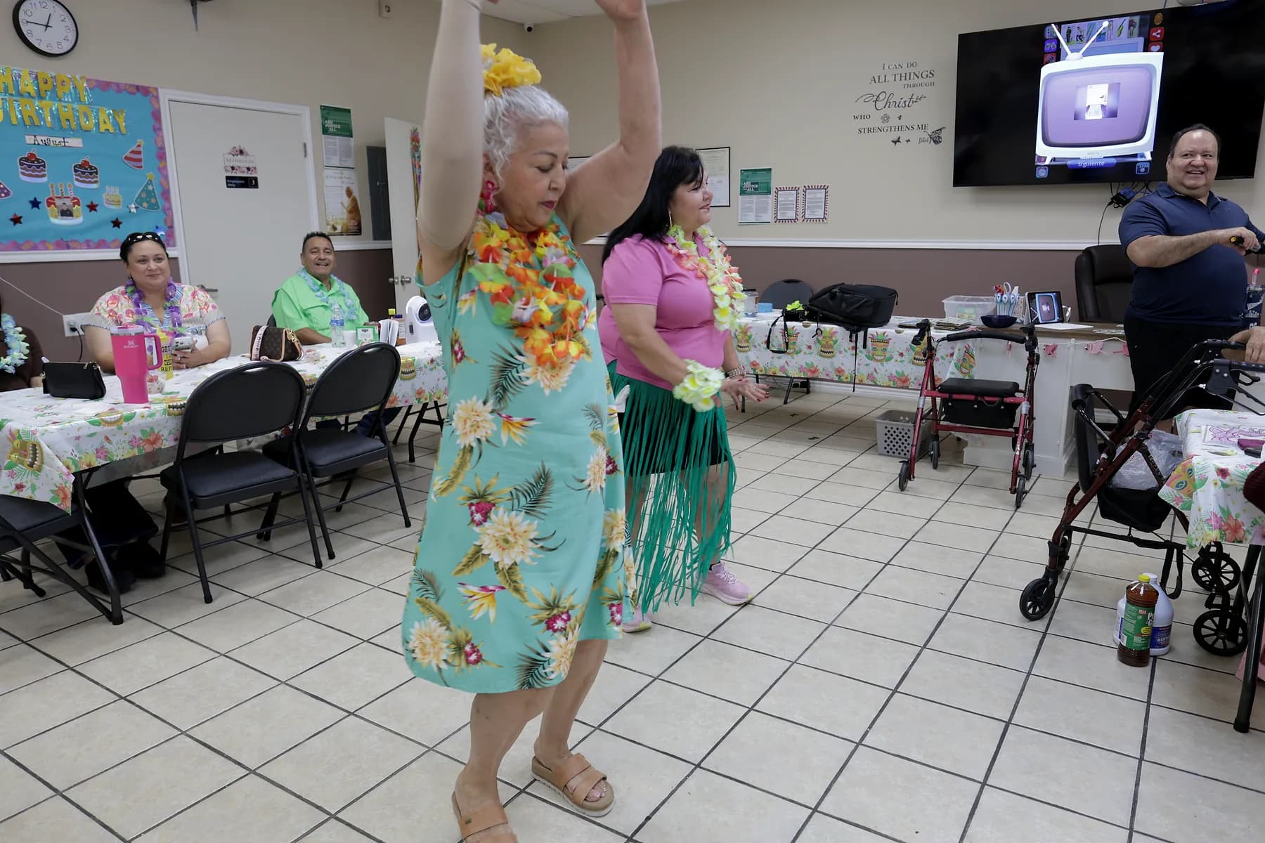 A participant dancing with her arms raised