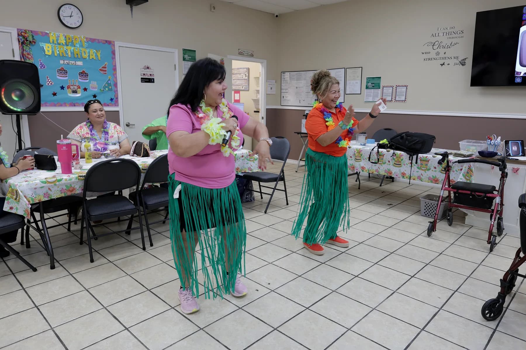 Two people dancing together on the open floor of the activity room