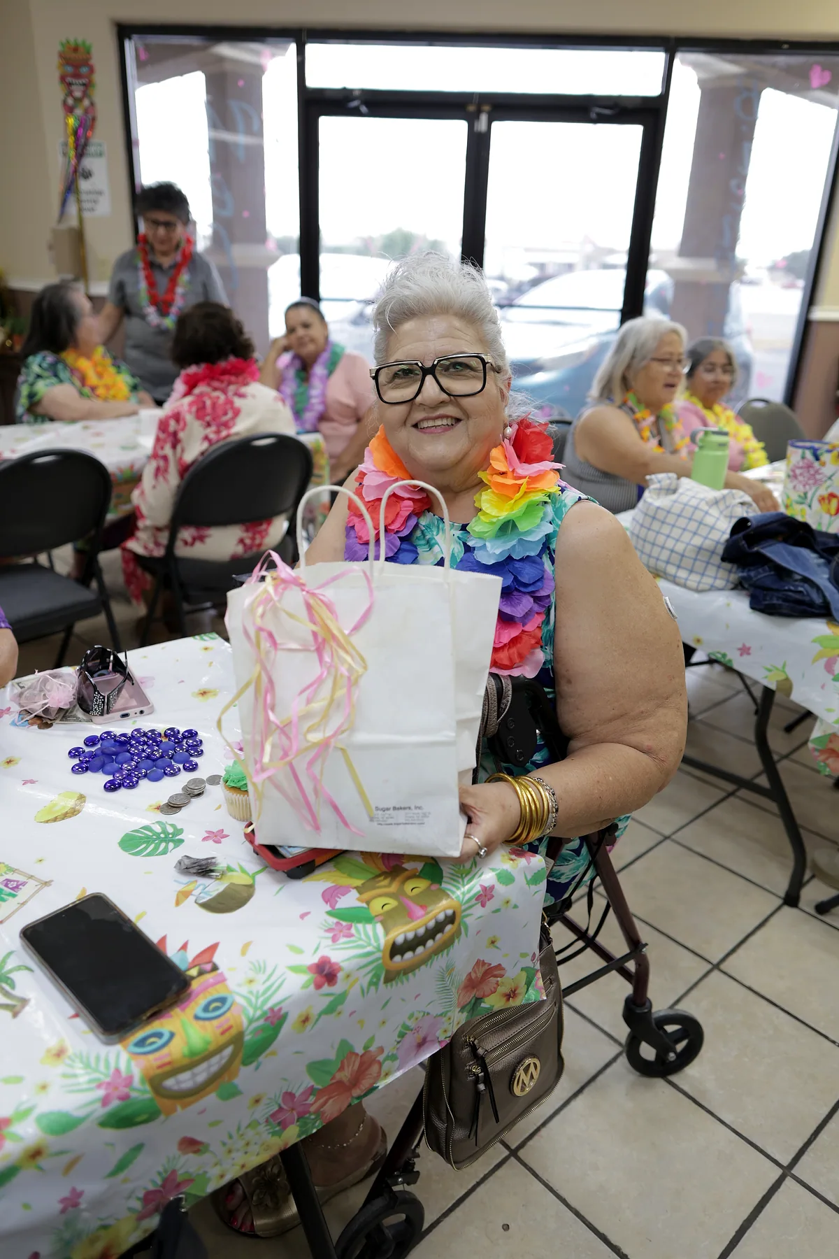 A participant holding up a gift bag she was given