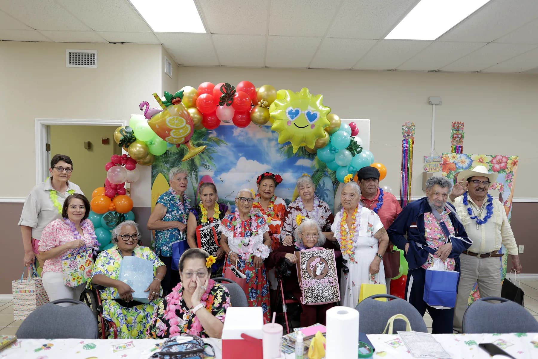 A group of participants and staff posed together under the balloon arch