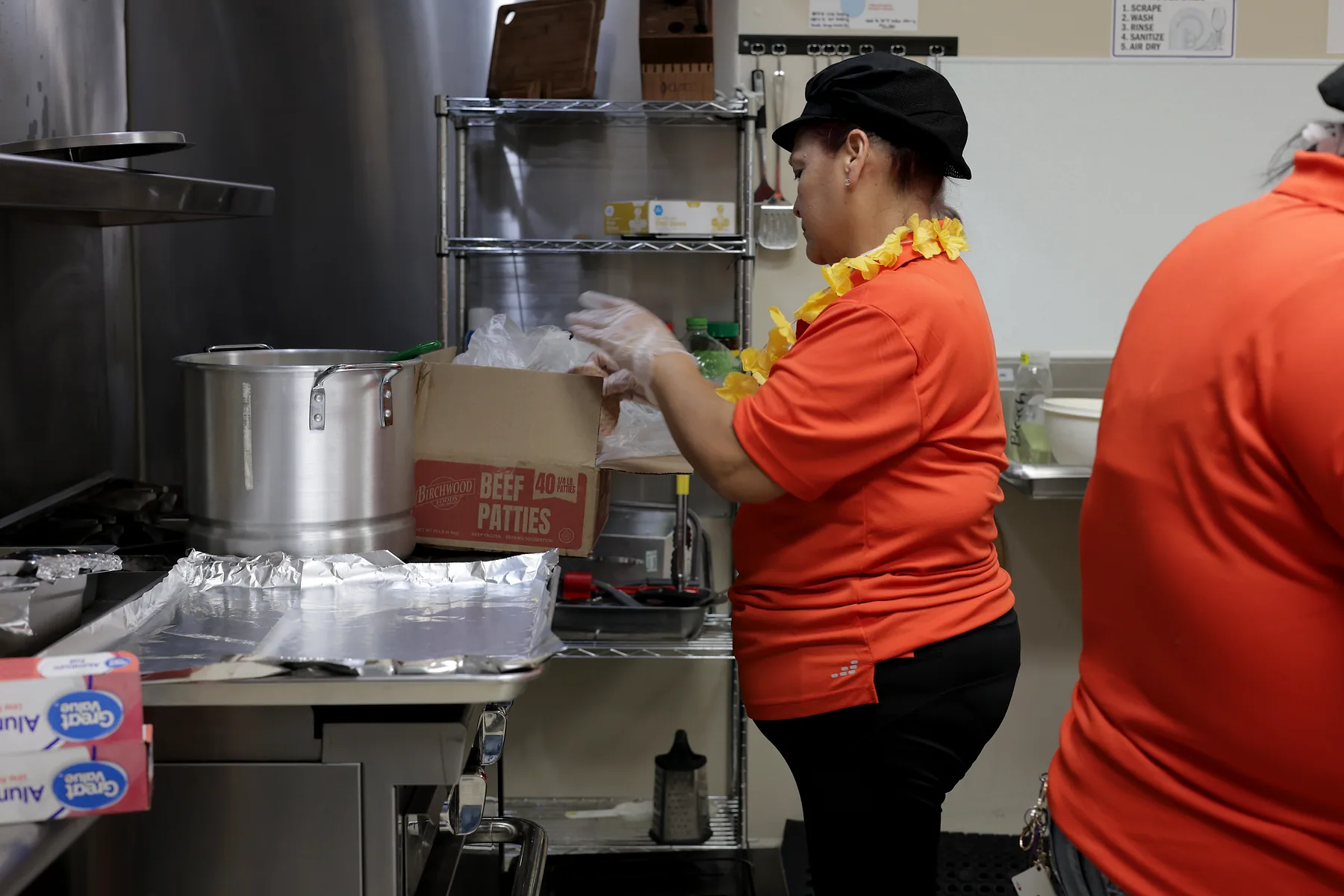 Kitchen staff cooking the day's hot meal on the stove