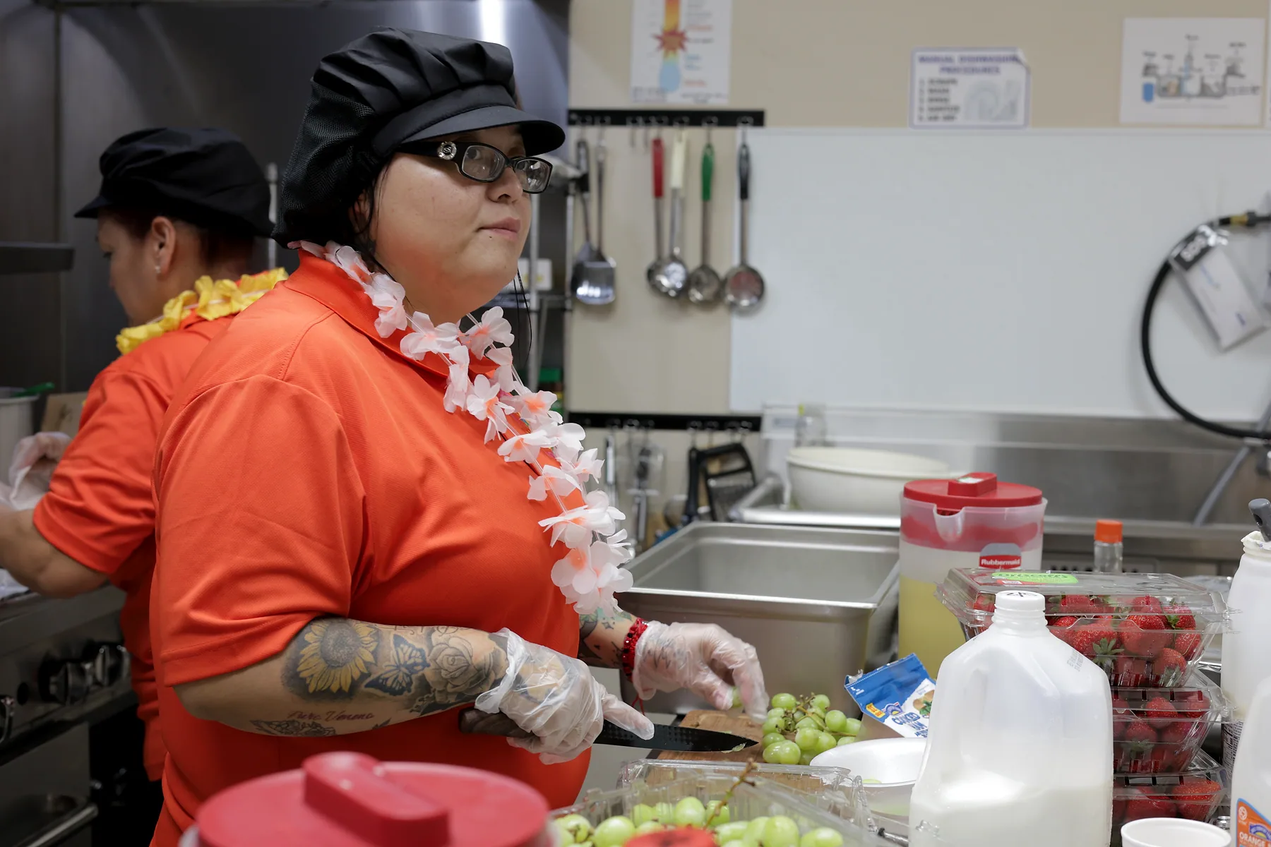 Kitchen staff preparing fresh fruit for the day's meals