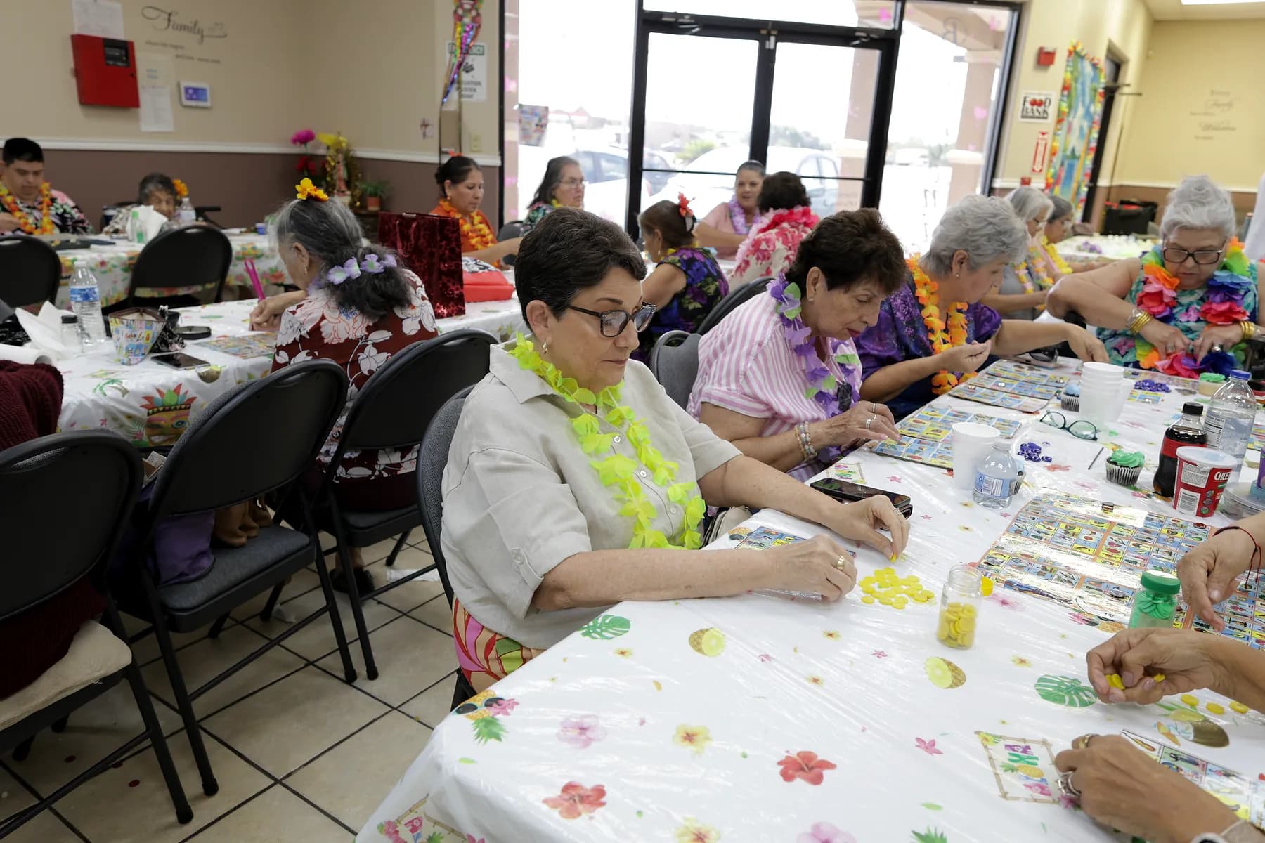 Close view of lotería boards and coloured markers in play