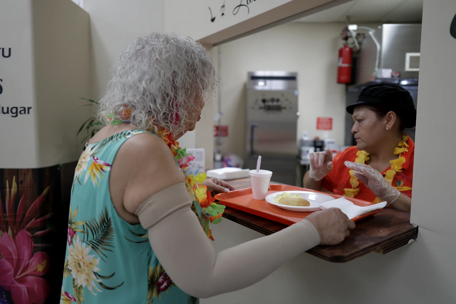 A meal tray handed across the serving counter