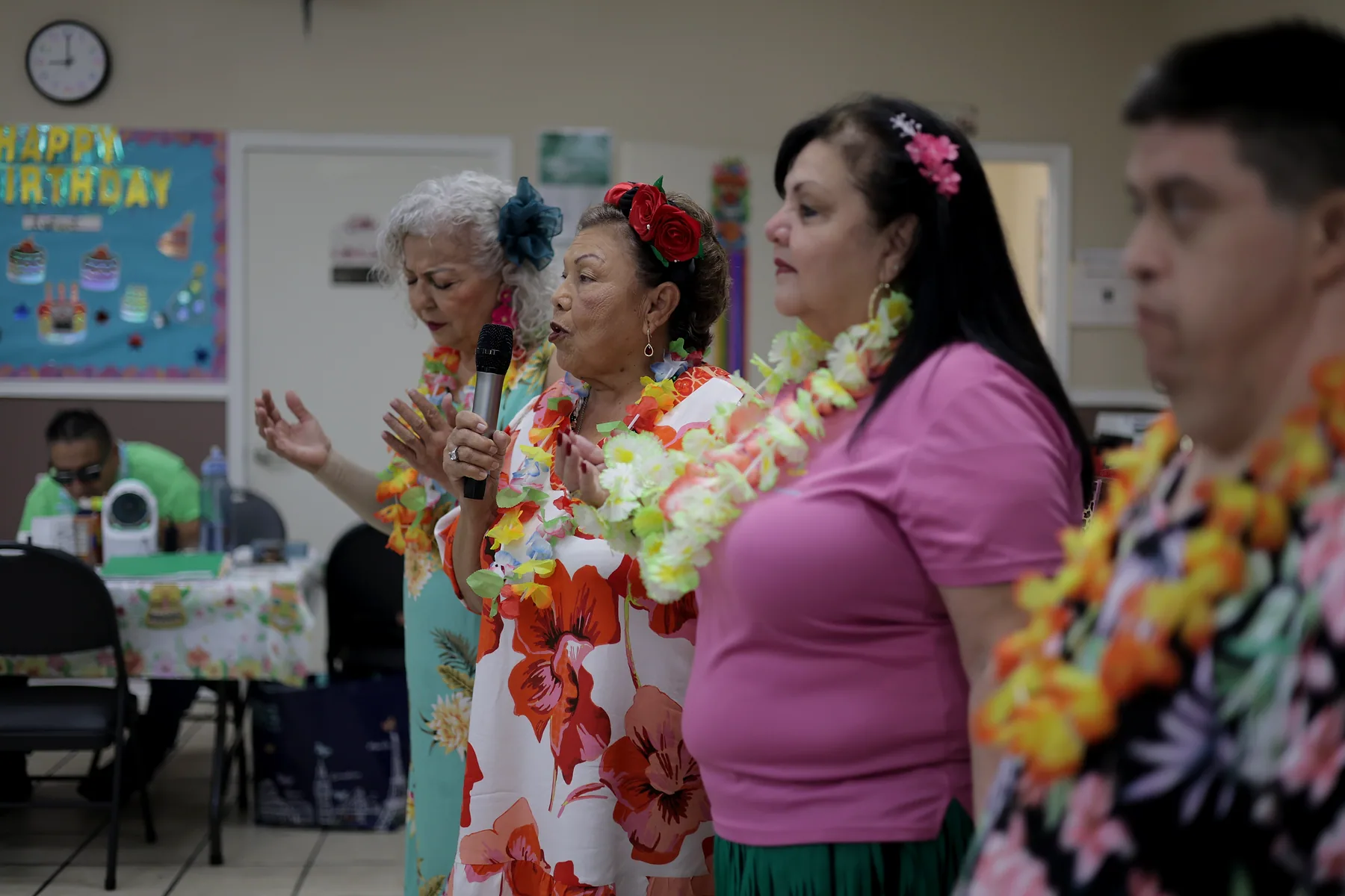 A group singing together around the microphone