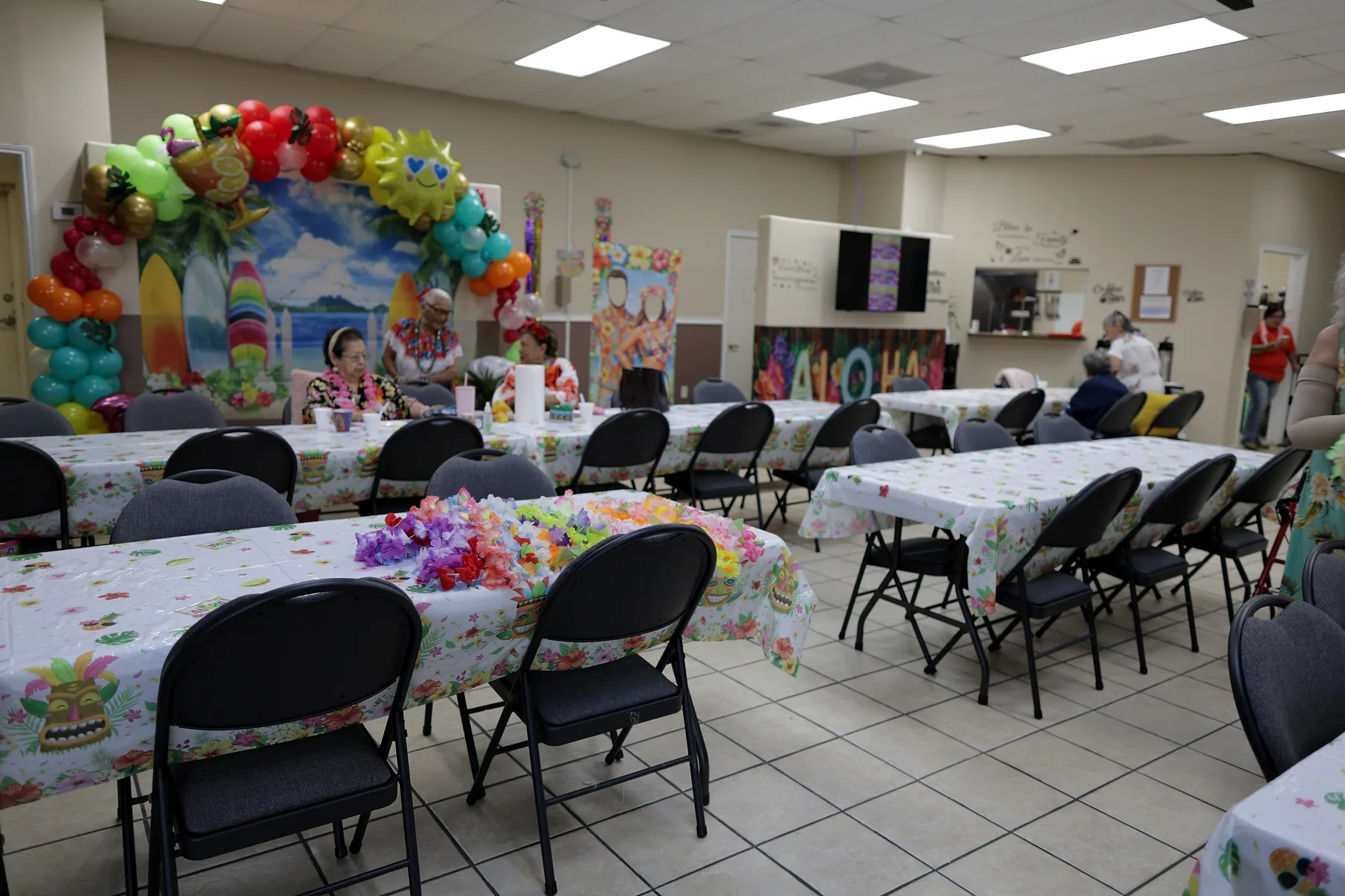 The main activity room at Amor Y Vida, tables set and ready for the day